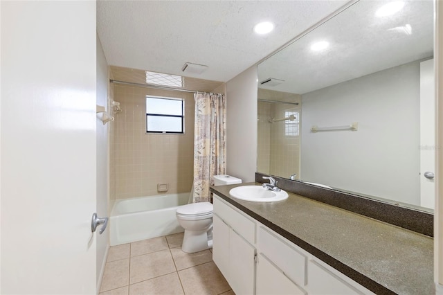 full bathroom featuring tile patterned floors, toilet, a textured ceiling, vanity, and shower / bathtub combination with curtain