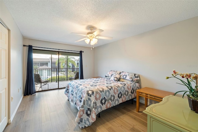 bedroom with a textured ceiling, access to exterior, ceiling fan, and light hardwood / wood-style floors