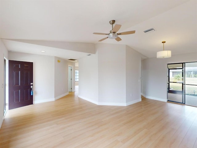 empty room featuring ceiling fan, light hardwood / wood-style floors, and lofted ceiling