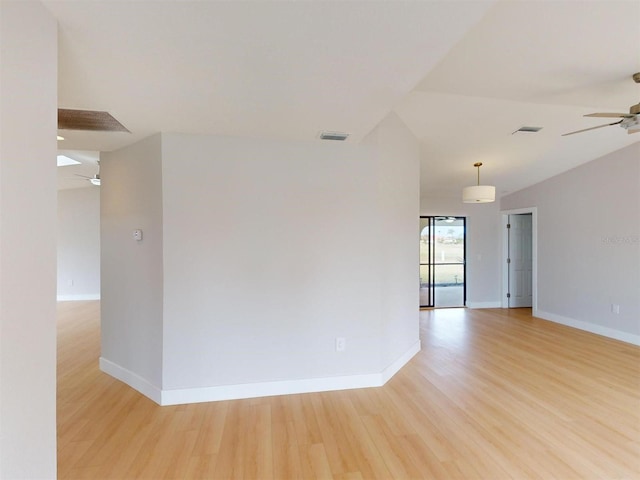 empty room featuring ceiling fan, light hardwood / wood-style flooring, and lofted ceiling