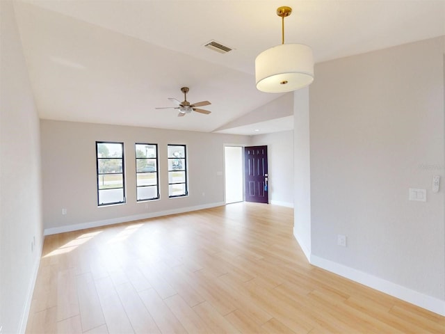 spare room featuring ceiling fan, light hardwood / wood-style flooring, and vaulted ceiling