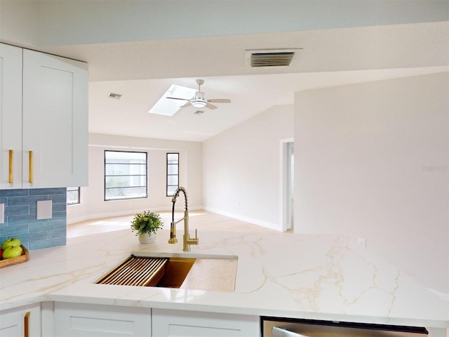 kitchen featuring sink and white cabinets