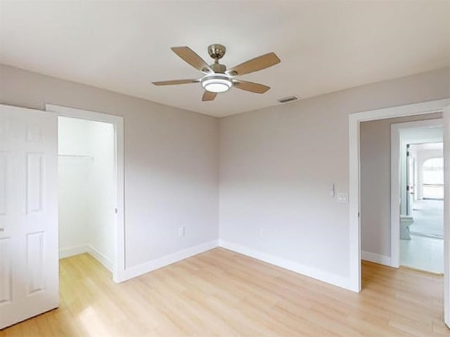 spare room featuring light wood-type flooring and ceiling fan