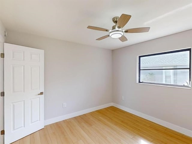 empty room featuring ceiling fan and hardwood / wood-style floors