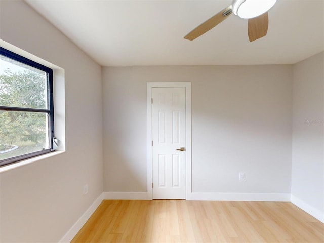 unfurnished room with ceiling fan and wood-type flooring