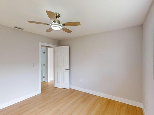 empty room with light hardwood / wood-style flooring and ceiling fan