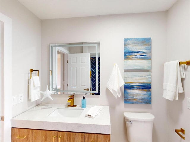 bathroom with toilet and vanity