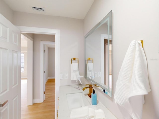 bathroom with hardwood / wood-style floors and vanity