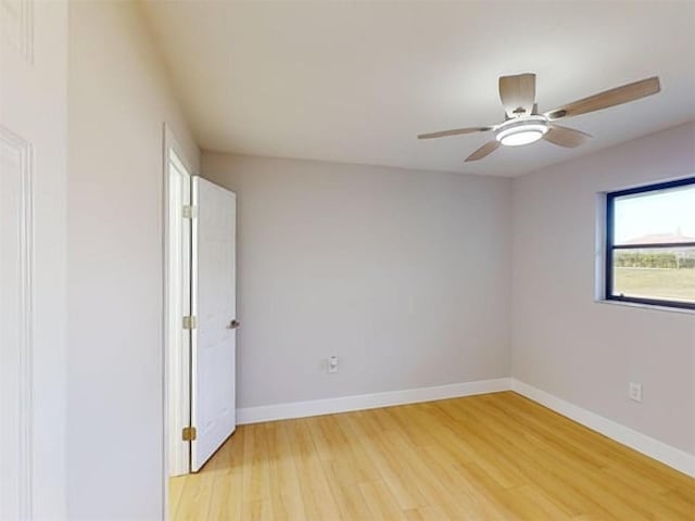 spare room featuring hardwood / wood-style floors and ceiling fan