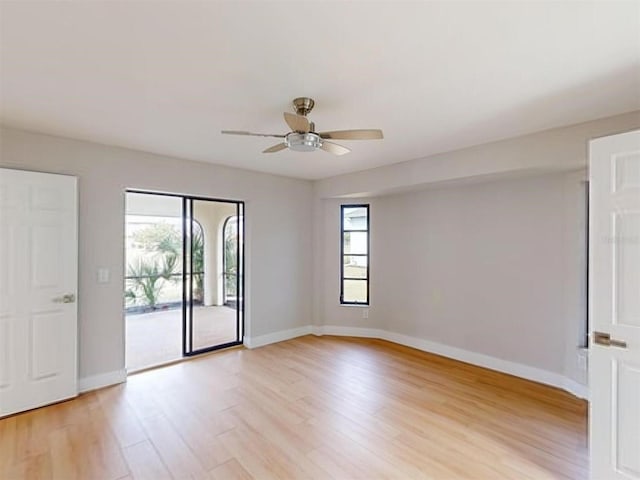 empty room with ceiling fan and light hardwood / wood-style floors