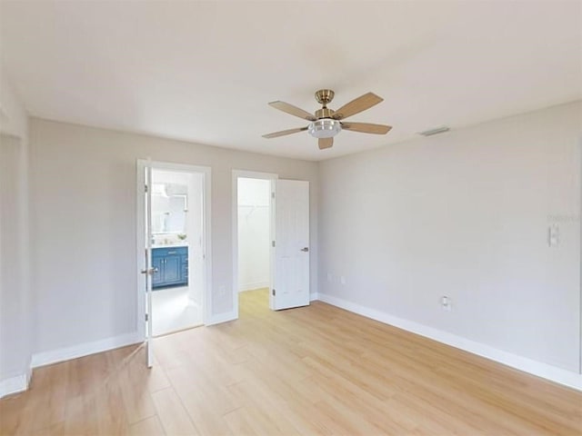 unfurnished room featuring light wood-type flooring and ceiling fan