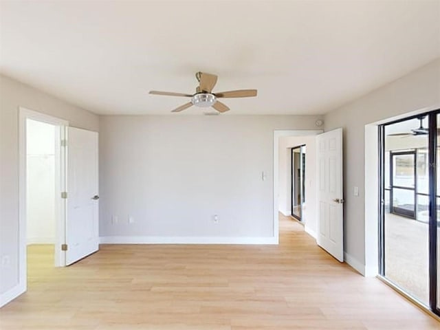 empty room featuring ceiling fan and light hardwood / wood-style floors