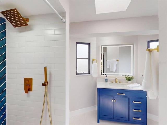 bathroom featuring walk in shower, vanity, and a healthy amount of sunlight