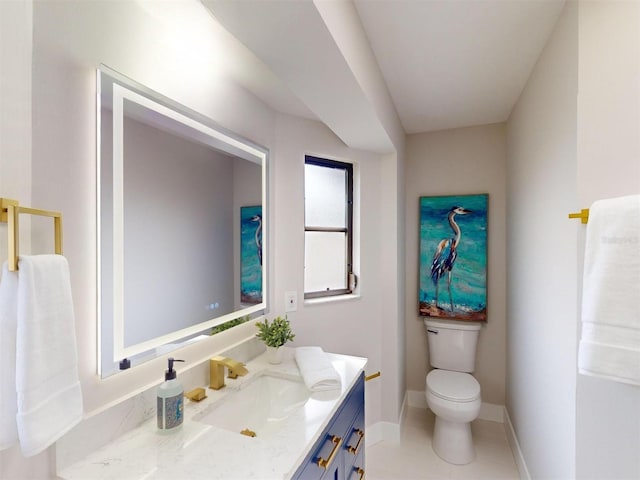 bathroom featuring toilet, tile patterned flooring, and vanity