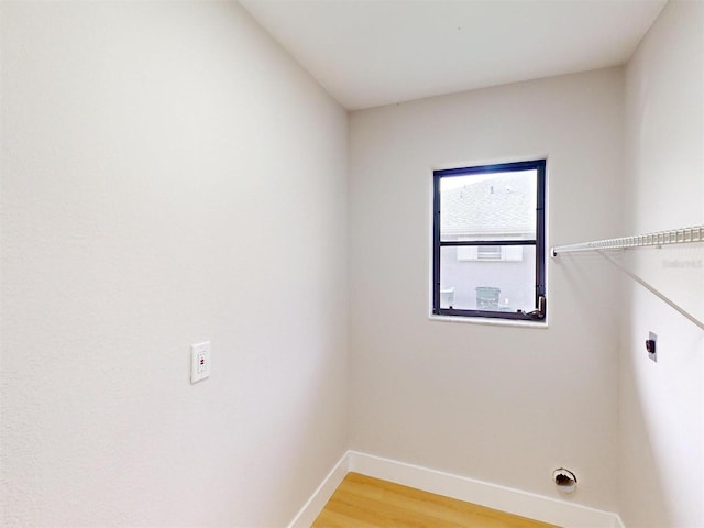 clothes washing area featuring hookup for an electric dryer and hardwood / wood-style floors