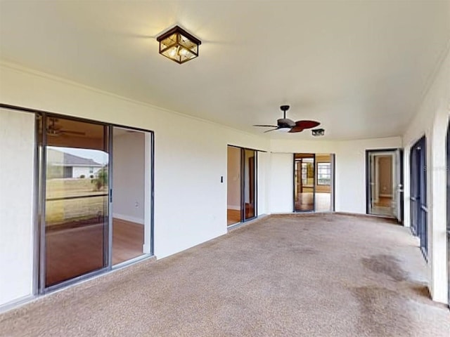 interior space featuring ceiling fan and a healthy amount of sunlight