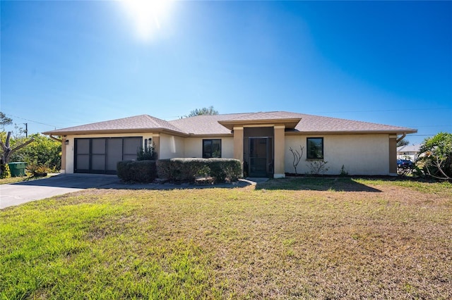 view of front of property featuring a garage and a front yard