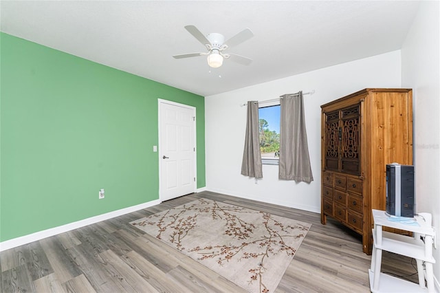 unfurnished room featuring hardwood / wood-style flooring and ceiling fan