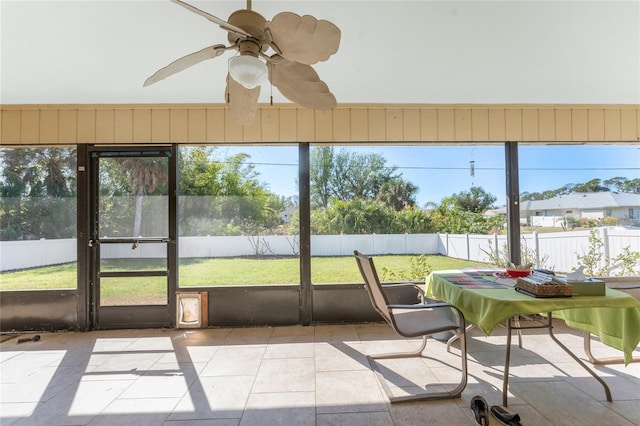 sunroom featuring ceiling fan and a healthy amount of sunlight