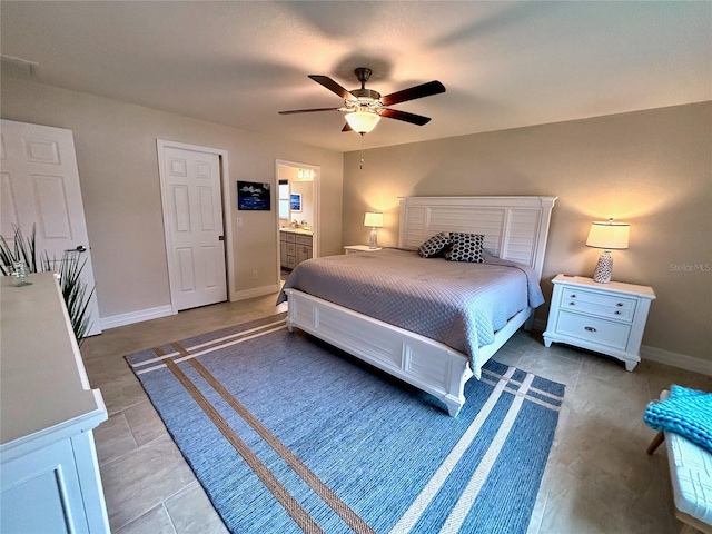 bedroom featuring connected bathroom, tile patterned floors, and ceiling fan