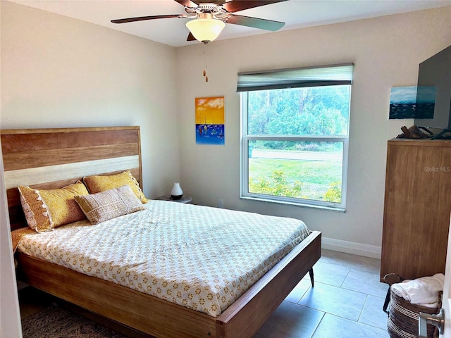 bedroom with tile patterned floors and ceiling fan