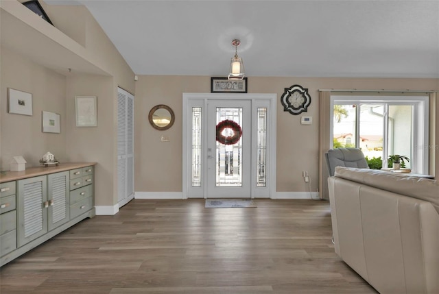 entryway featuring light hardwood / wood-style flooring and lofted ceiling