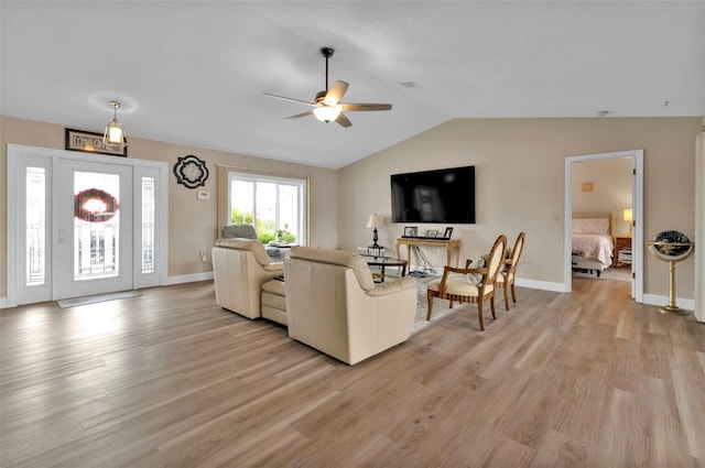 living room featuring light wood-type flooring, ceiling fan, and lofted ceiling