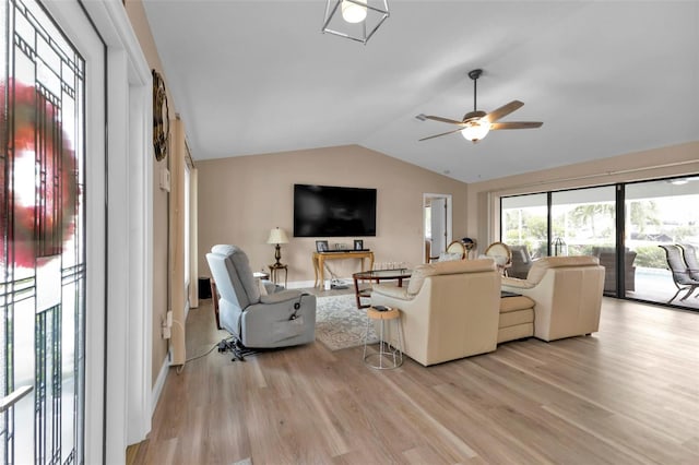 living room with ceiling fan, light hardwood / wood-style flooring, and lofted ceiling