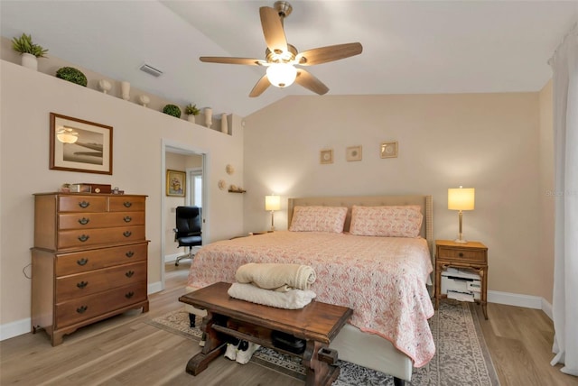 bedroom with ceiling fan, light hardwood / wood-style floors, and lofted ceiling