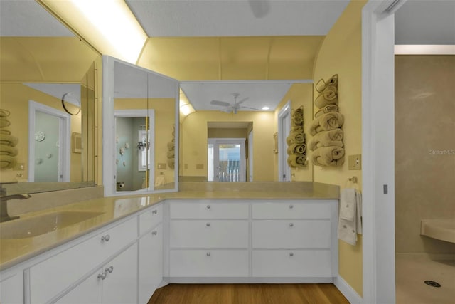 bathroom with wood-type flooring, ceiling fan, and vanity