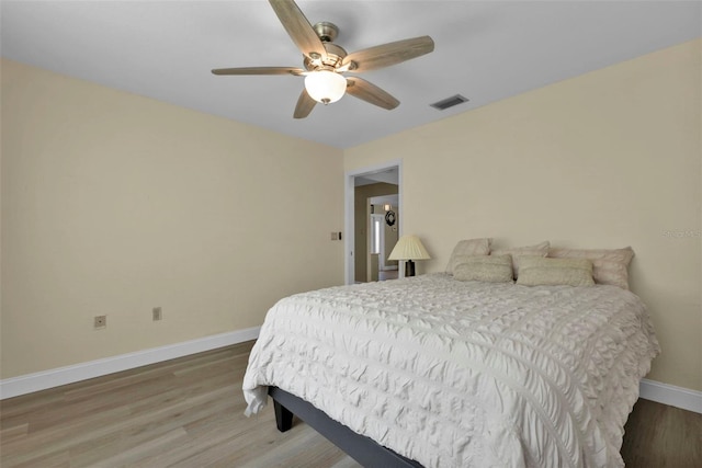 bedroom with wood-type flooring and ceiling fan