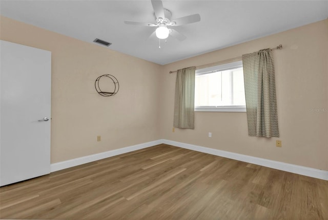 unfurnished room featuring ceiling fan and hardwood / wood-style floors