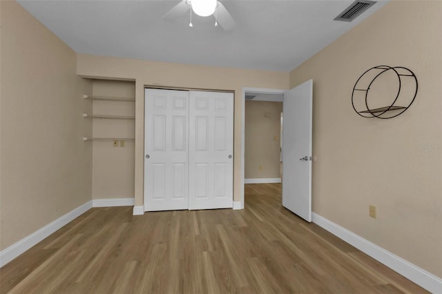 unfurnished bedroom featuring light hardwood / wood-style floors, a closet, and ceiling fan