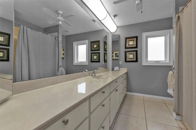 bathroom featuring a textured ceiling, tile patterned floors, ceiling fan, and vanity