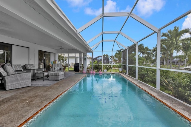 view of pool featuring a lanai, a patio, outdoor lounge area, and ceiling fan