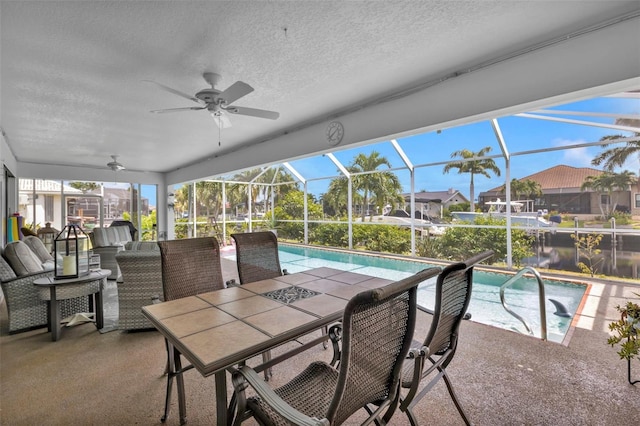 exterior space featuring ceiling fan, outdoor lounge area, and glass enclosure