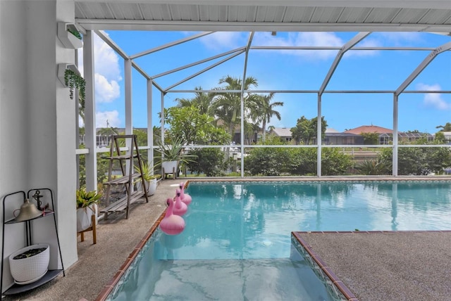 view of pool featuring glass enclosure and a patio