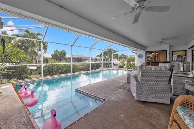 view of swimming pool with ceiling fan, outdoor lounge area, glass enclosure, and a patio