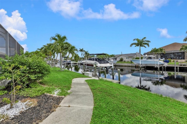 dock area featuring a water view and a lawn