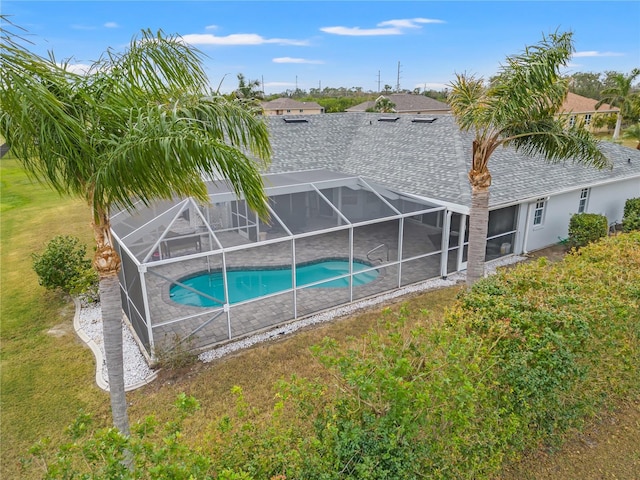 view of pool with a lanai and a yard