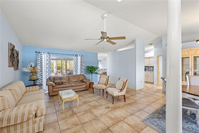 living room with ceiling fan, light tile patterned floors, and lofted ceiling