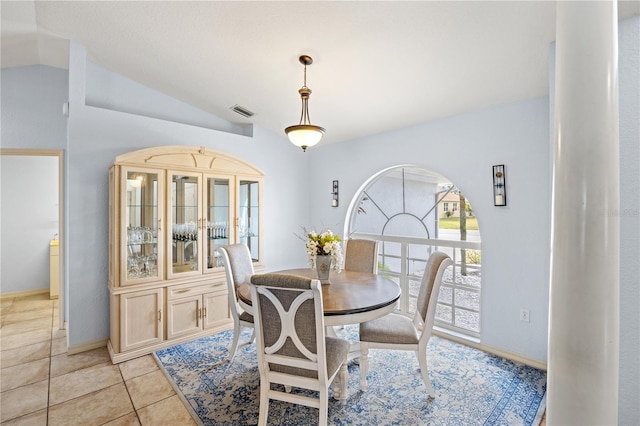 tiled dining area with lofted ceiling