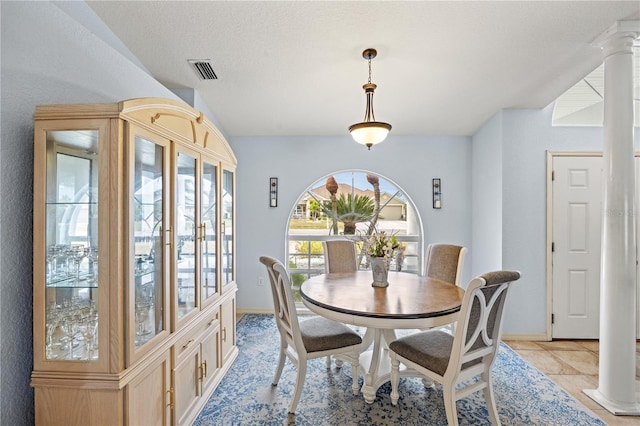 dining space with decorative columns