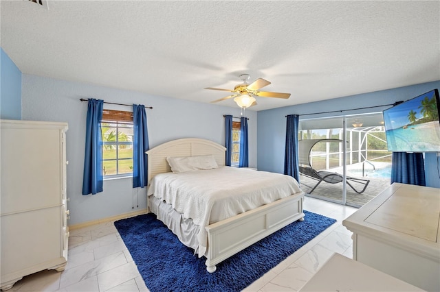 bedroom with ceiling fan, a textured ceiling, and access to outside