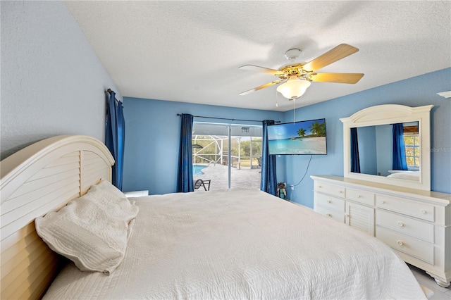 bedroom with ceiling fan, access to exterior, and a textured ceiling