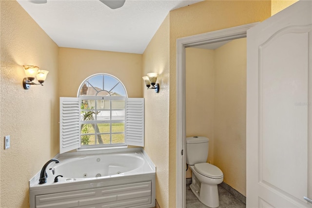 bathroom featuring toilet and a tub