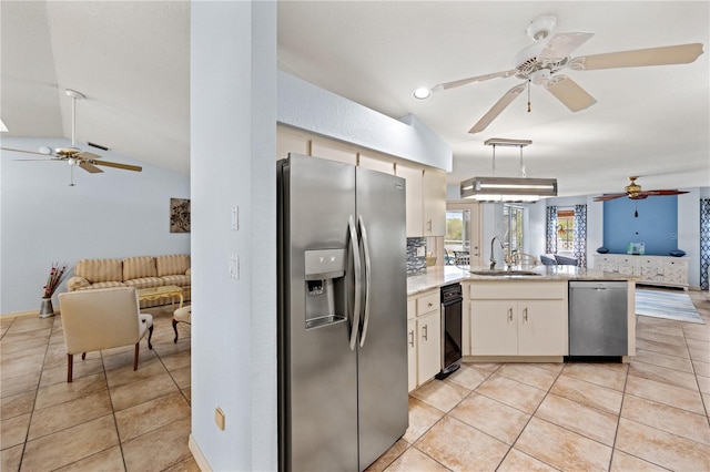 kitchen featuring white cabinetry, stainless steel appliances, sink, kitchen peninsula, and vaulted ceiling