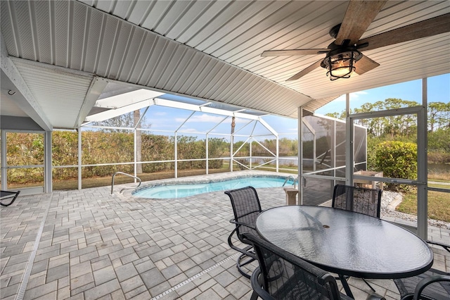 view of swimming pool with a lanai, a patio area, and ceiling fan