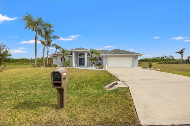 view of front of home with a garage and a front yard