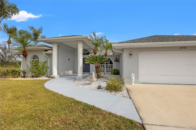 view of front of house with a front yard and a garage